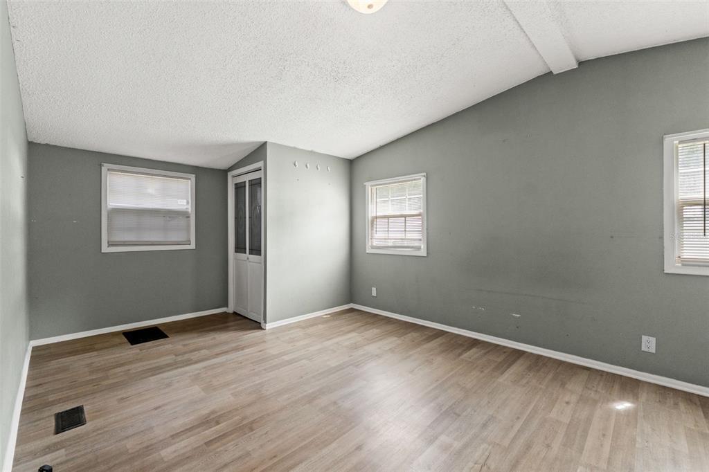 7610 County Road 663 Bushnell, FL 33513 - Photo 24 of 43 an empty room with wooden floor and windows