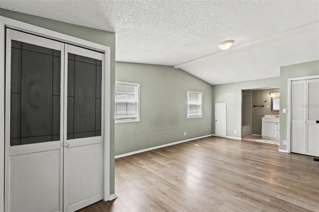 7610 County Road 663 Bushnell, FL 33513 - Photo 25 of 43 a view of an empty room with wooden floor and a window