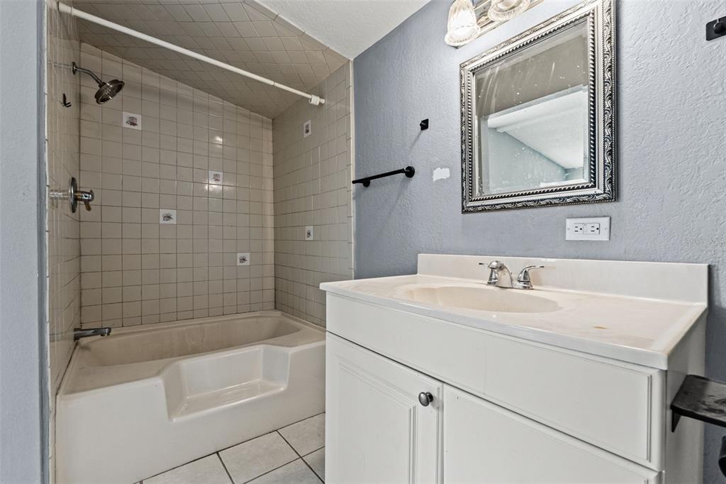 7610 County Road 663 Bushnell, FL 33513 - Photo 26 of 43 a bathroom with a sink vanity mirror toilet and bathtub