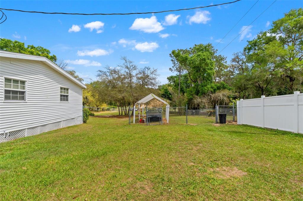 7610 County Road 663 Bushnell, FL 33513 - Photo 30 of 43 a front view of a house with a yard and trees