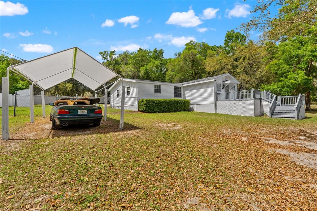 7610 County Road 663 Bushnell, FL 33513 - Photo 3 of 43 a house view with a garden space