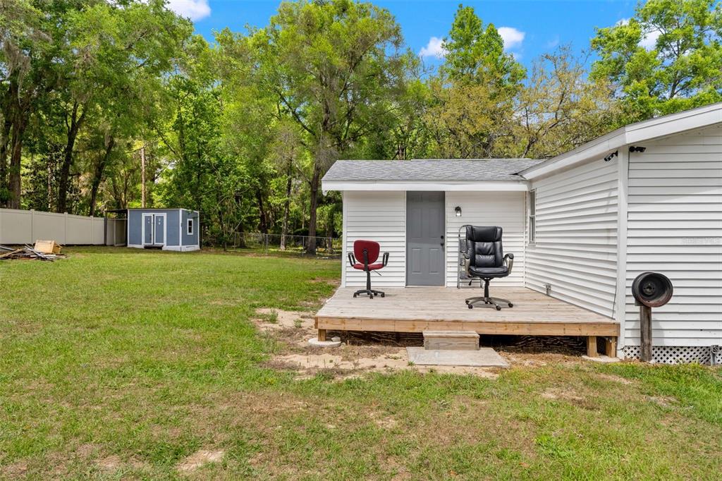 7610 County Road 663 Bushnell, FL 33513 - Photo 31 of 43 a view of a house with backyard and sitting area