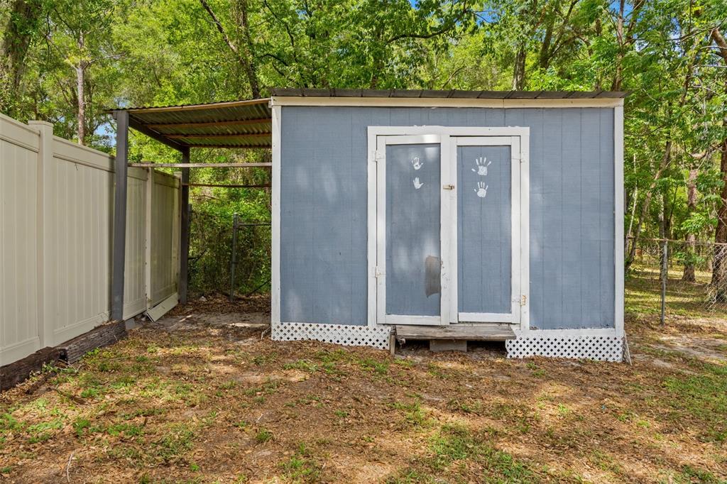 7610 County Road 663 Bushnell, FL 33513 - Photo 35 of 43 a view of small house with backyard