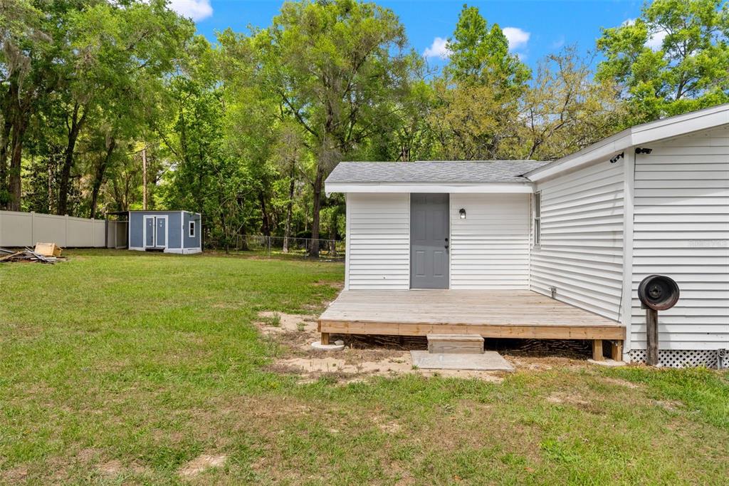 7610 County Road 663 Bushnell, FL 33513 - Photo 37 of 43 a view of a house with backyard and a tree