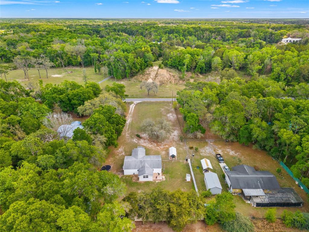 7610 County Road 663 Bushnell, FL 33513 - Photo 41 of 43 an aerial view of a house with a yard