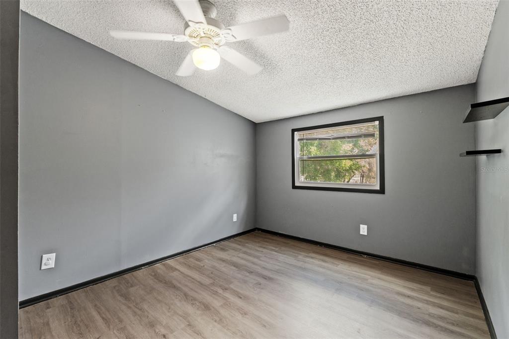 7610 County Road 663 Bushnell, FL 33513 - Photo 6 of 43 an empty room with a ceiling fan and a window