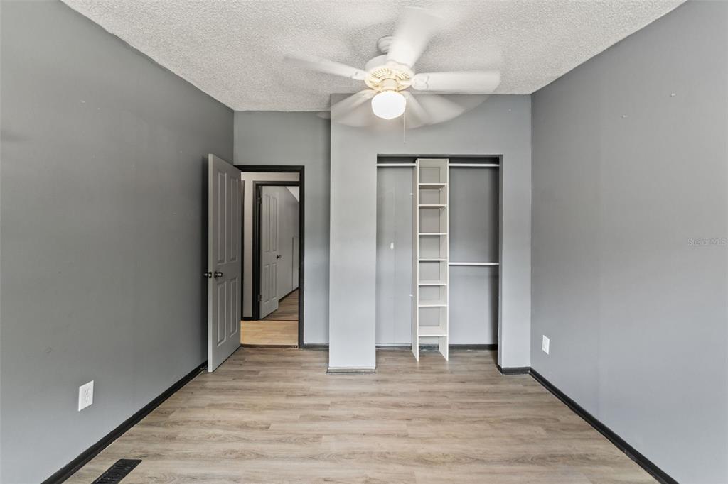 7610 County Road 663 Bushnell, FL 33513 - Photo 7 of 43 wooden floor in an empty room with a window