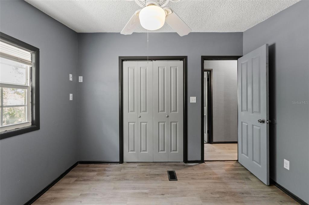 7610 County Road 663 Bushnell, FL 33513 - Photo 9 of 43 wooden floor in an empty room with a window