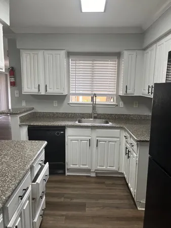 a view of empty room with wooden floor and fireplace