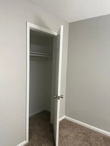a kitchen with granite countertop a sink stove and cabinets