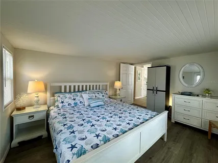 a bedroom with a large bed and a dresser