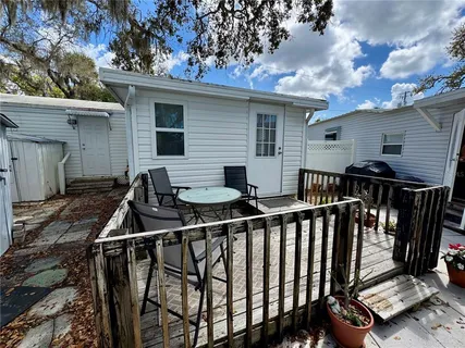 a view of balcony with two chairs and a barbeque