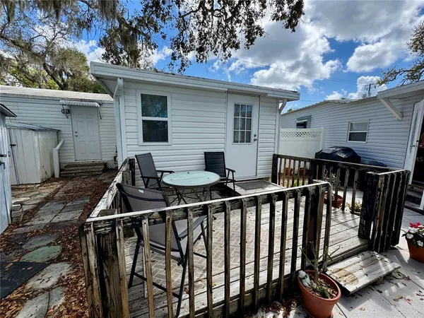 a view of balcony with two chairs and a barbeque