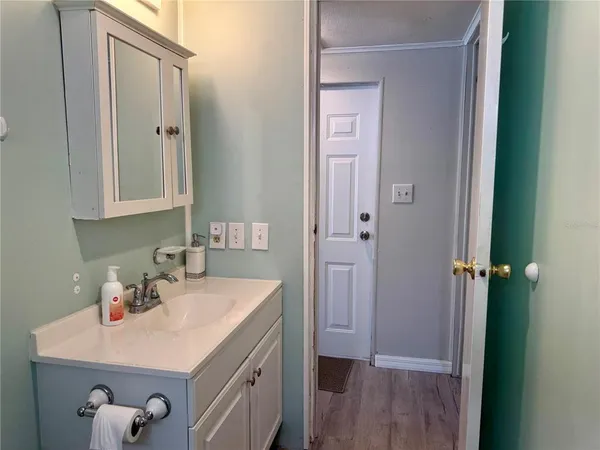 a bathroom with a sink a mirror and vanity