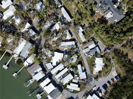 an aerial view of multiple houses with yard