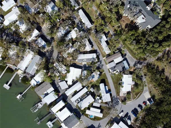 an aerial view of multiple houses with yard