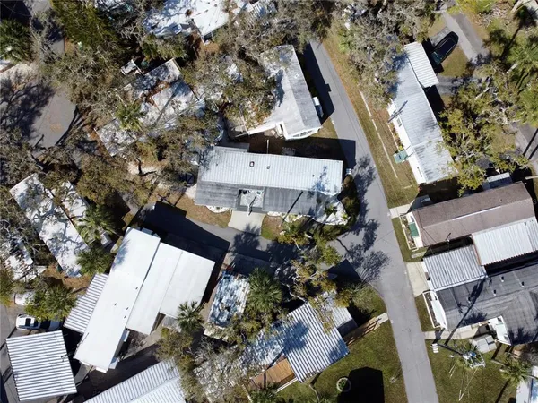 an aerial view of a house with a yard and fountain in front of it