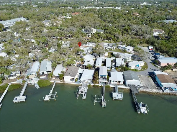 an aerial view of residential houses with outdoor space and trees
