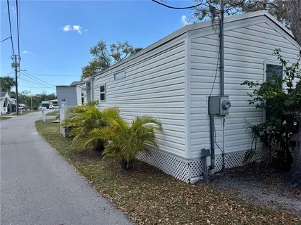 a view of a house with a yard and potted plants