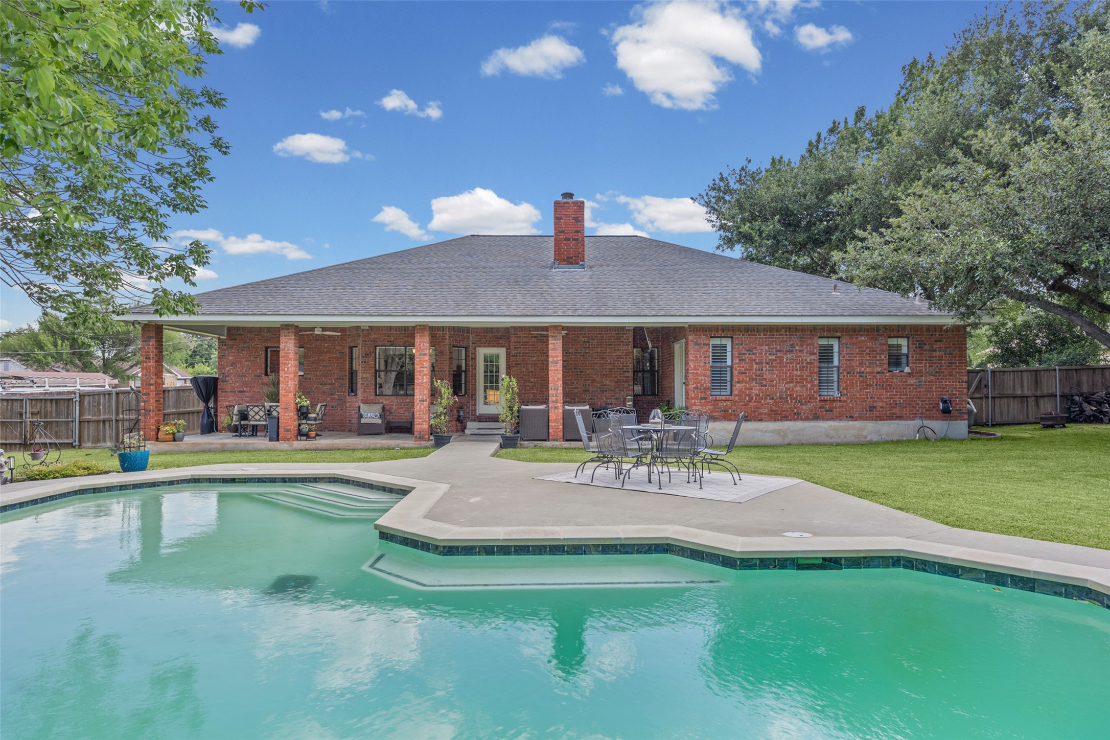 2000 Spinel Road Pflugerville, TX 78660 - Photo 26 of 31 An inviting backyard oasis offers a sparkling in-ground pool and ample patio space for leisure.