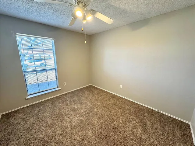 an empty room with a empty space and windows