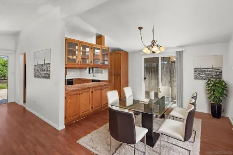 a dining room with furniture and wooden floor