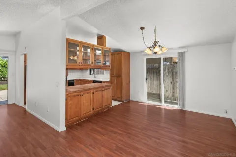 a view of kitchen with granite countertop cabinets and wooden floor