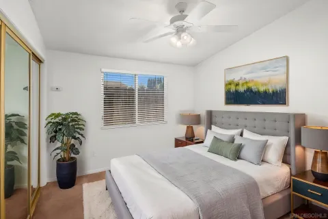 a bedroom with a large bed and a chandelier
