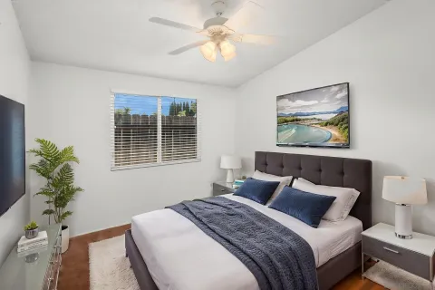 a bedroom with a bed and a painting on the wall
