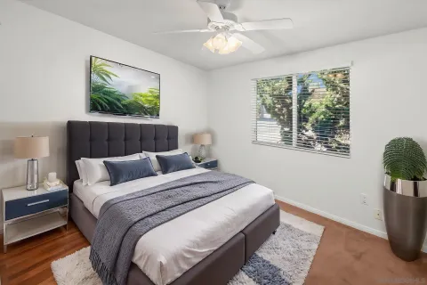 a bedroom with a bed and a painting on the wall
