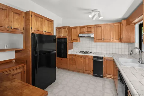 a kitchen with a sink stove and refrigerator