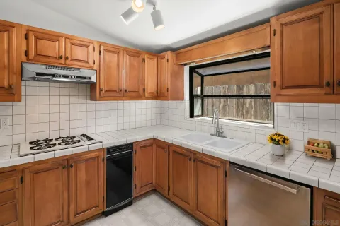 a kitchen with stainless steel appliances a stove sink and cabinets