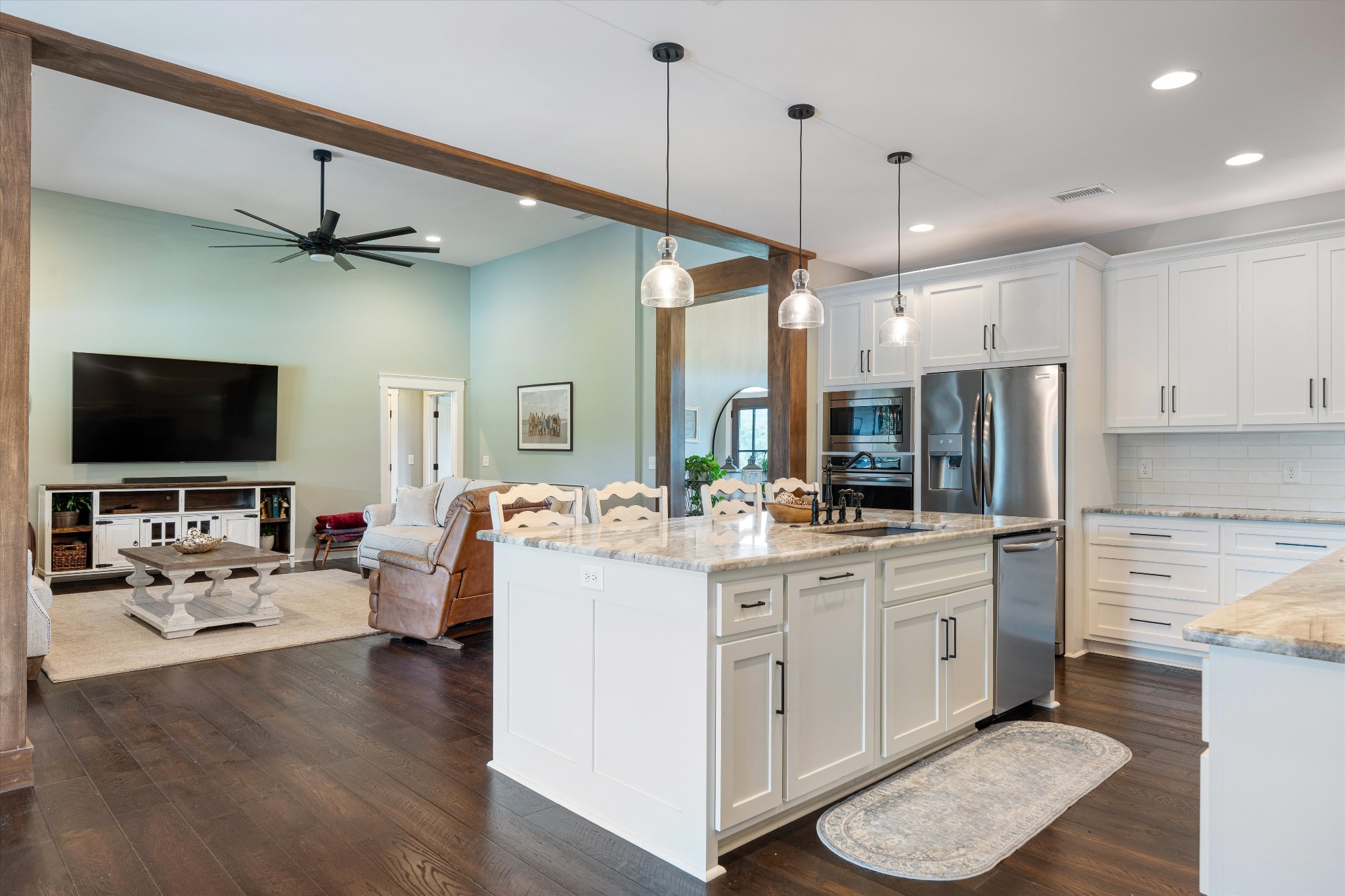 420 Fite Road Watertown, TN 37184 - Photo 33 of 76 a kitchen with stainless steel appliances a stove a sink dishwasher a refrigerator and a dining table with wooden floor