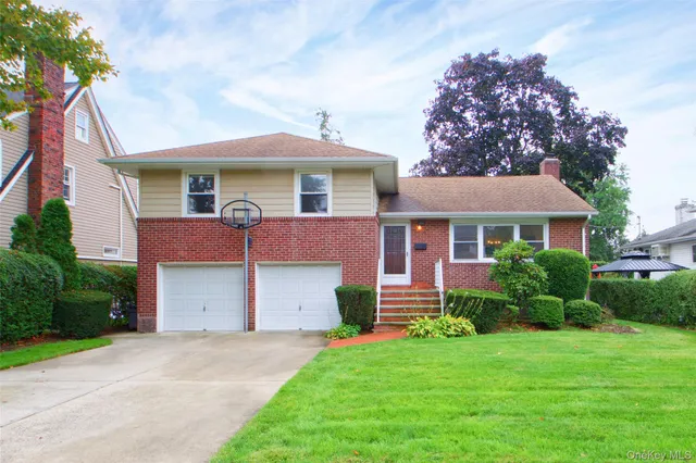 a front view of a house with a yard and garage