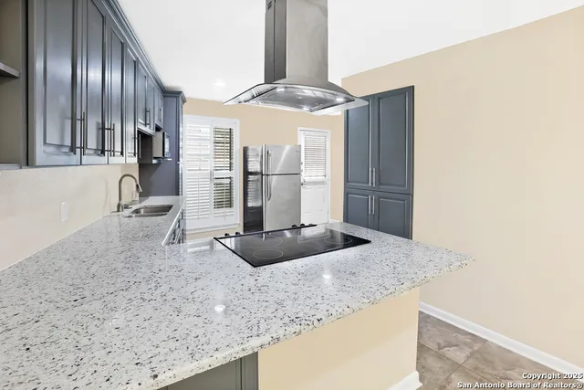 a kitchen with stainless steel appliances granite countertop a sink and a granite counter tops