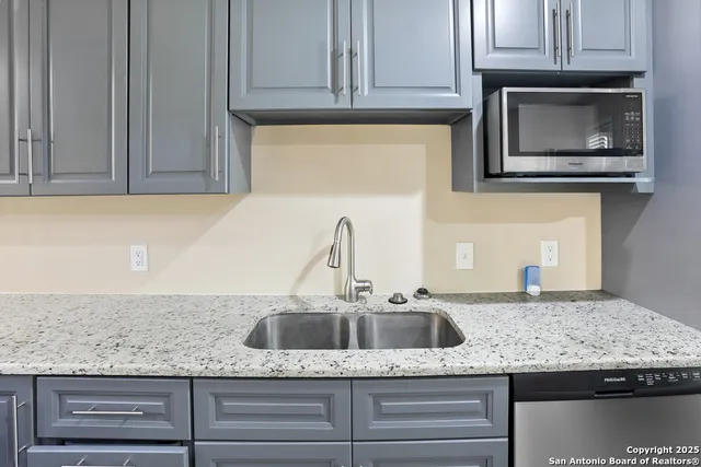 a kitchen with granite countertop cabinets and stainless steel appliances