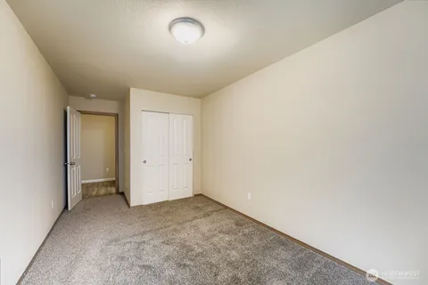 an empty room with a empty space and windows