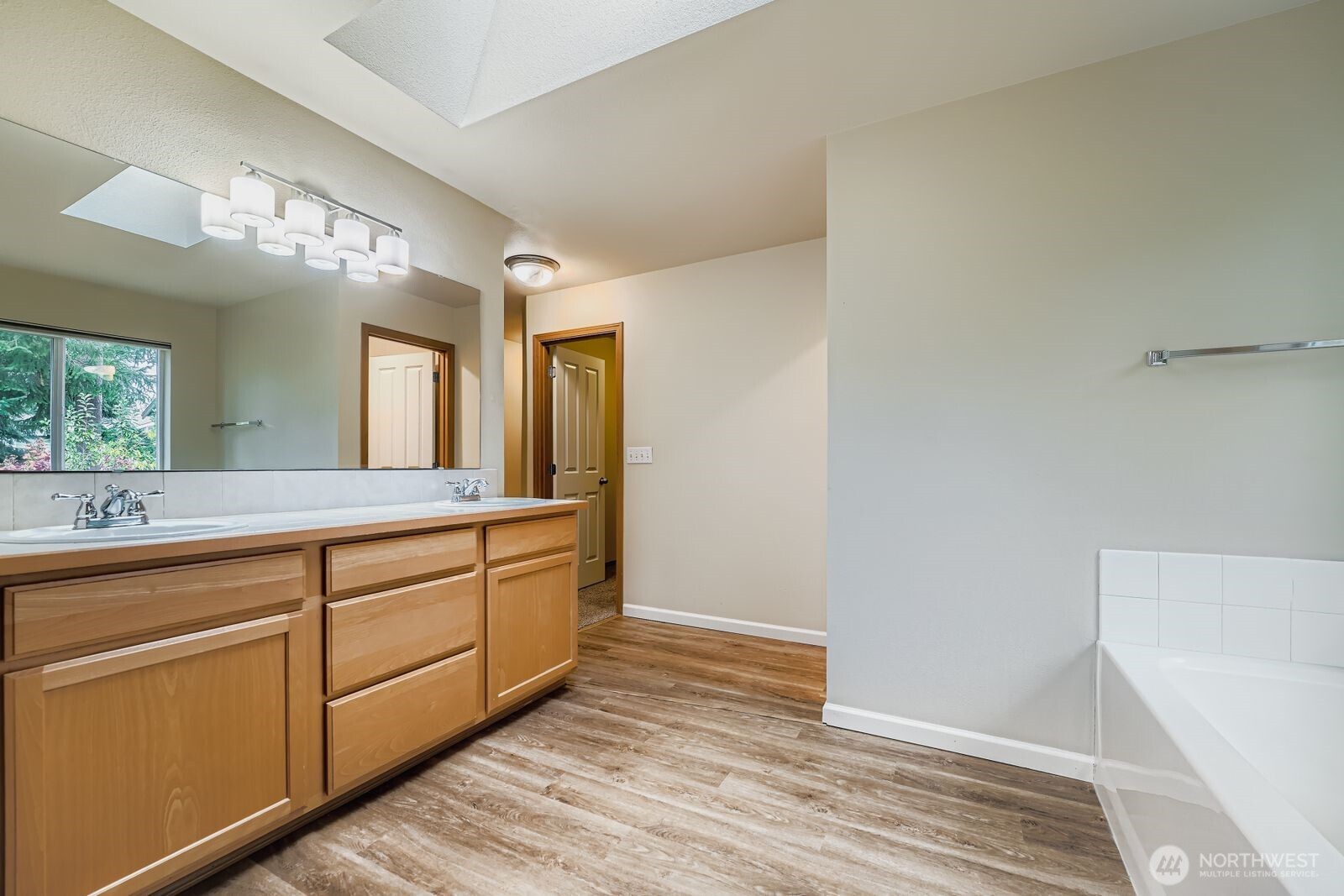 27030 228th Place Southeast Maple Valley, WA 98038 - Photo 22 of 36 a spacious bathroom with a double vanity sink and a mirror