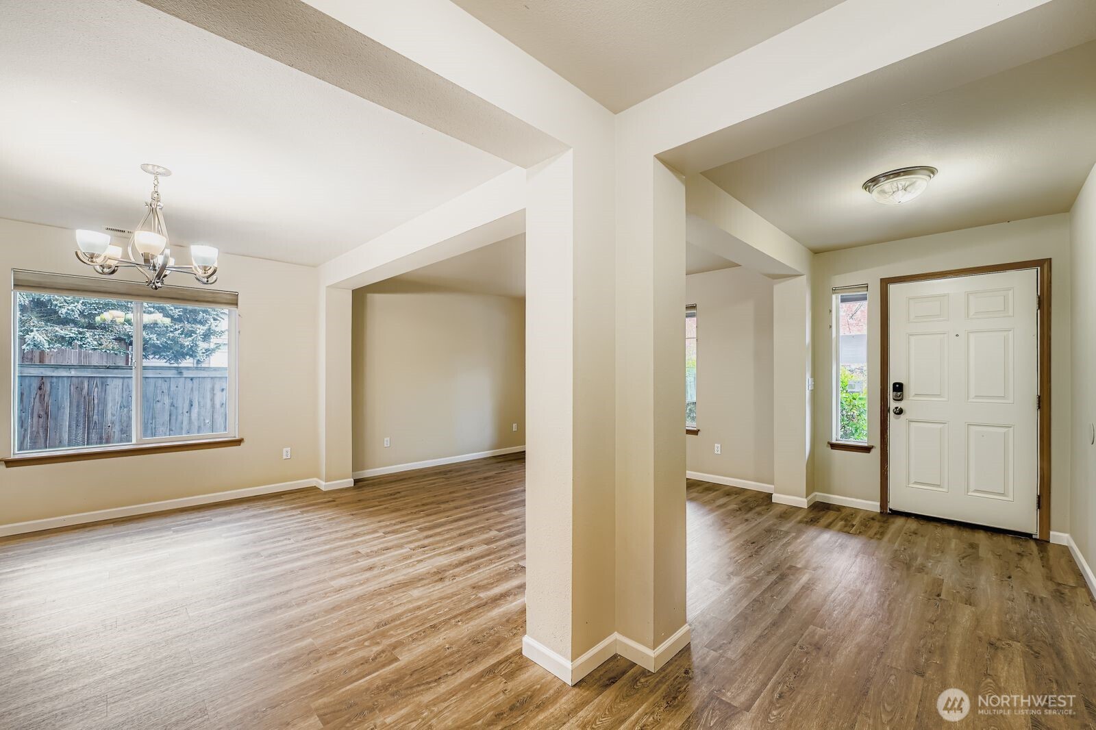 27030 228th Place Southeast Maple Valley, WA 98038 - Photo 4 of 36 an empty room with wooden floor cabinet and windows