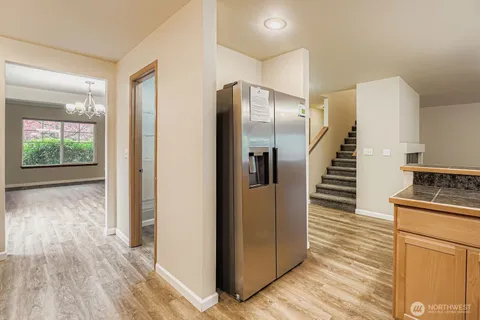 a view of a kitchen with wooden floor and electronic appliances