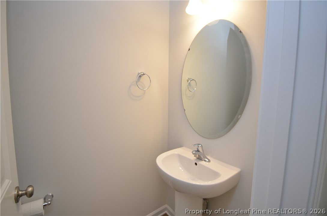5405 Short Leaf Road Fayetteville, NC 28311 - Photo 12 of 29 a bathroom with a sink and a mirror