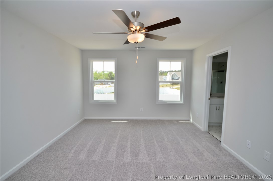5405 Short Leaf Road Fayetteville, NC 28311 - Photo 16 of 29 a view of an empty room with window and a ceiling fan