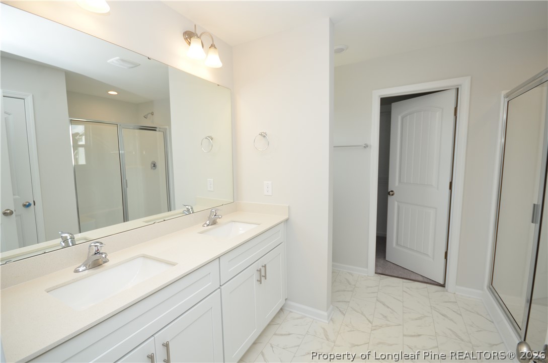 5405 Short Leaf Road Fayetteville, NC 28311 - Photo 18 of 29 a spacious bathroom with a double vanity sink mirror and double