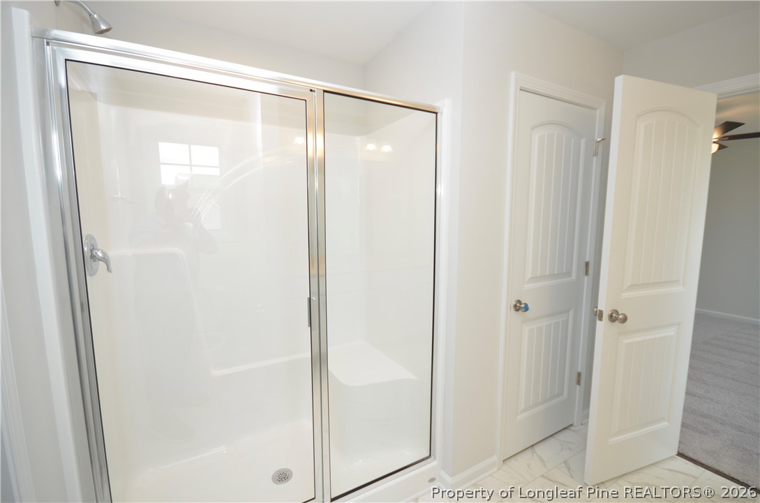 5405 Short Leaf Road Fayetteville, NC 28311 - Photo 19 of 29 a bathroom with a glass shower door