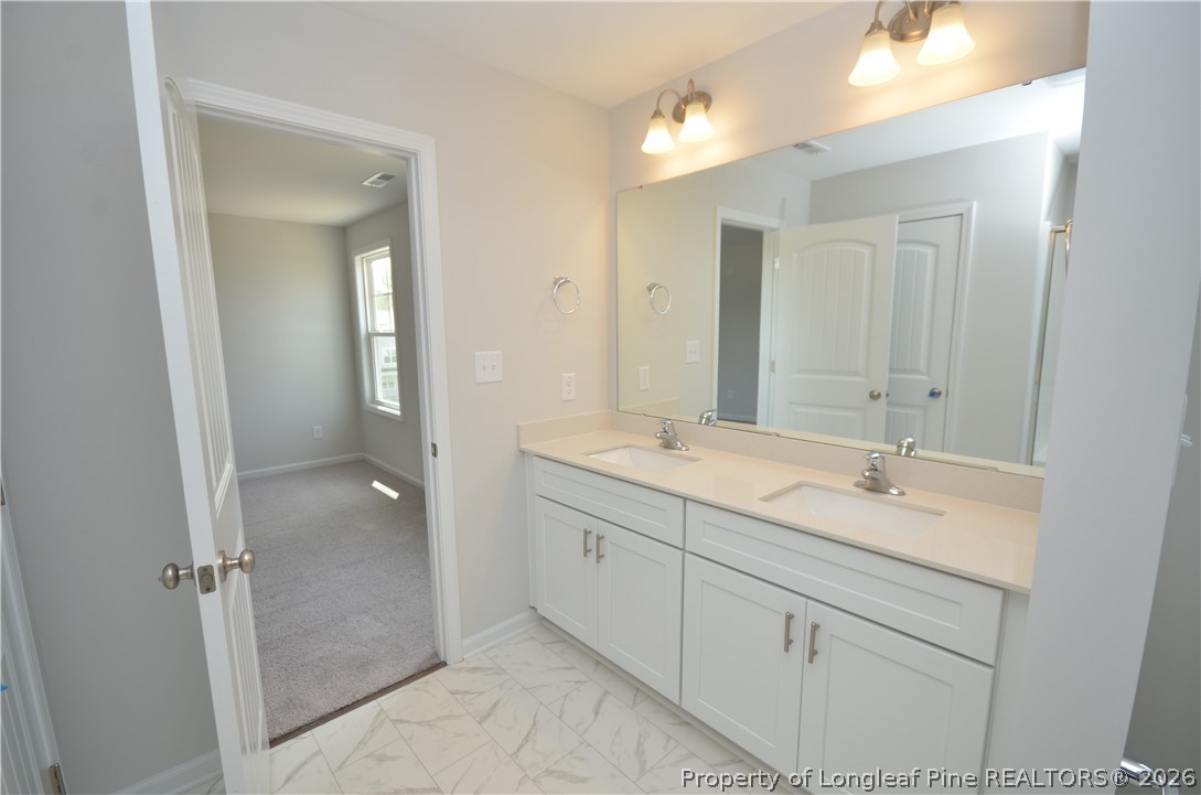 5405 Short Leaf Road Fayetteville, NC 28311 - Photo 20 of 29 a bathroom with a granite countertop sink mirror and double