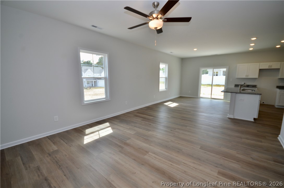 5405 Short Leaf Road Fayetteville, NC 28311 - Photo 2 of 29 a view of an empty room with window and wooden floor