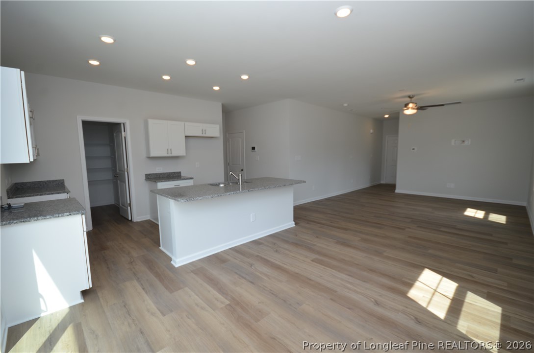 5405 Short Leaf Road Fayetteville, NC 28311 - Photo 7 of 29 a kitchen with a sink cabinets and wooden floor