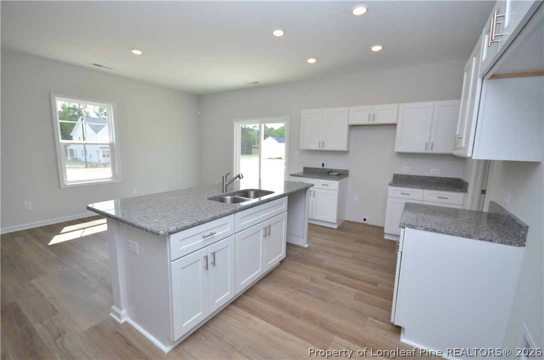 5405 Short Leaf Road Fayetteville, NC 28311 - Photo 9 of 29 a kitchen with granite countertop a sink stove and cabinets