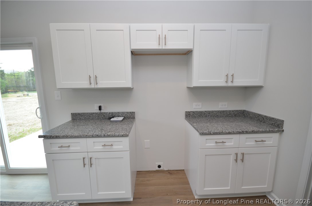 5405 Short Leaf Road Fayetteville, NC 28311 - Photo 10 of 29 a kitchen with granite countertop white cabinets and a stove