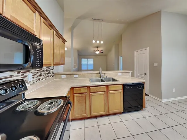 a kitchen with stainless steel appliances a sink stove and cabinets